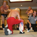 Dennis Condrey works on Ricky Morton's arm